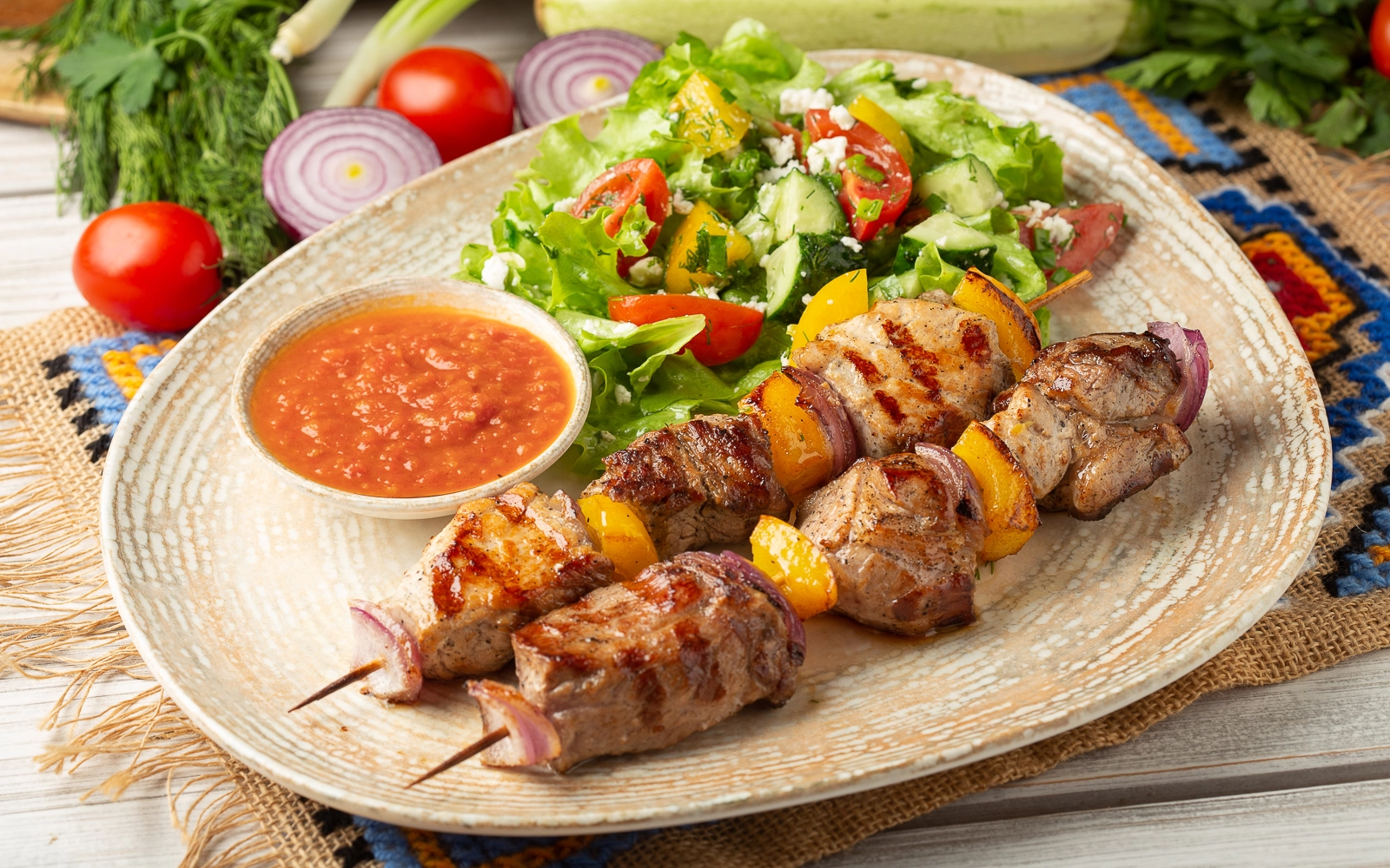 Pork shish kebab with salad and adjika